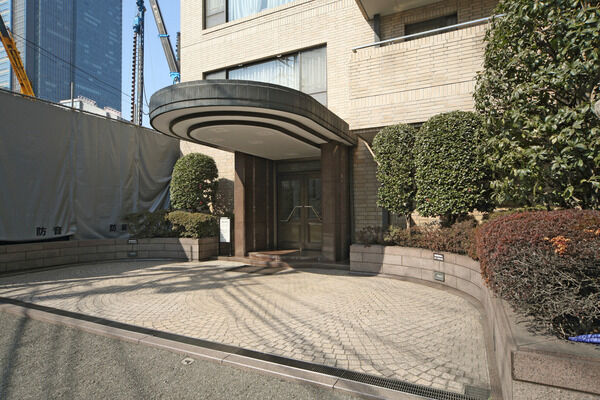 明るい日差しが降り注ぐアプローチは緑が映えるシックな色調。