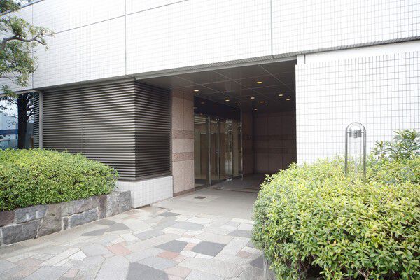 淡い照明が出迎えるエントランスは、常緑の植栽の奥に設置。		