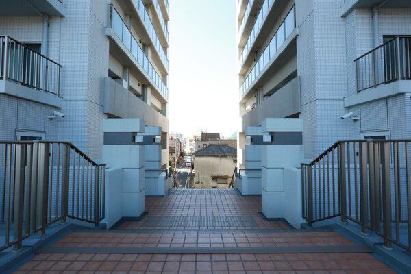 住居棟の間のデッキは、隅田川と閑静な住宅街をつなぐ。