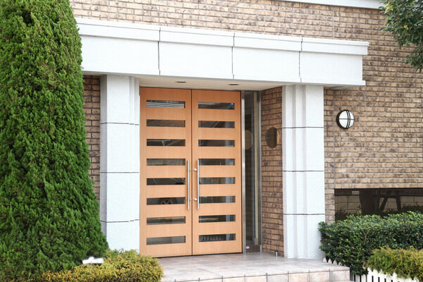 重厚感あふれる木製扉の先は温かみのあるエントランスホール。		