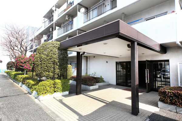 両側に品よく配列された植栽が暖かくお出迎えするエントランス。		