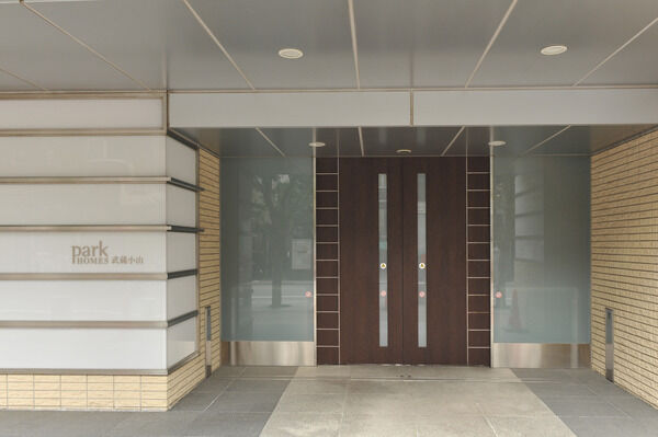 照明が組み込まれたガラスとメタル素材がシンボリックなエントランス。		