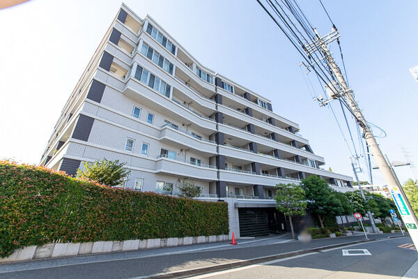 【ライオンズ日吉アーティスフォート】ライトグレーのタイル貼りにチャコールグレーの柱が印象的な外観デザイン。