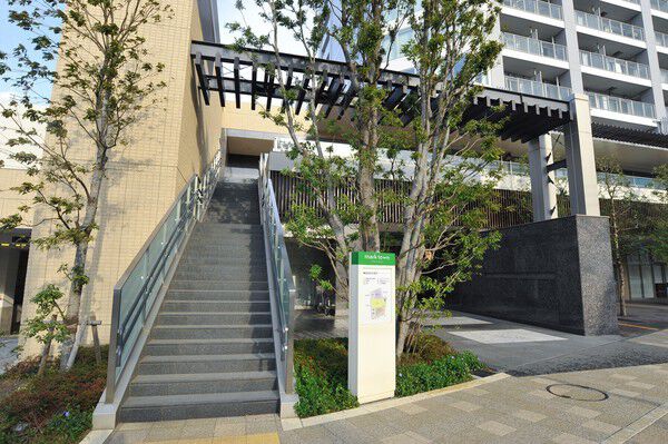 石の質感と木々の緑が爽やかなコントラストを描くエントランスアプローチ。		