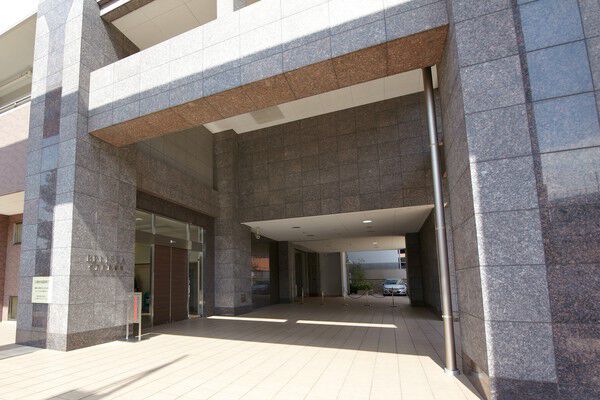 ゲートのように続く列柱の先に、重厚なグランドエントランスが佇みます。